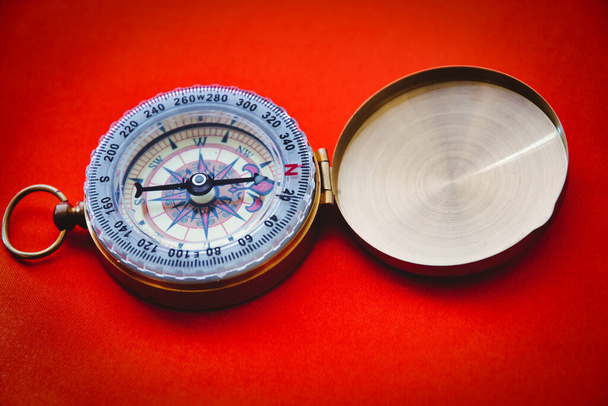 Vintage compass on red background, no people with copy space for concept or design - Fotografie, Obrázek