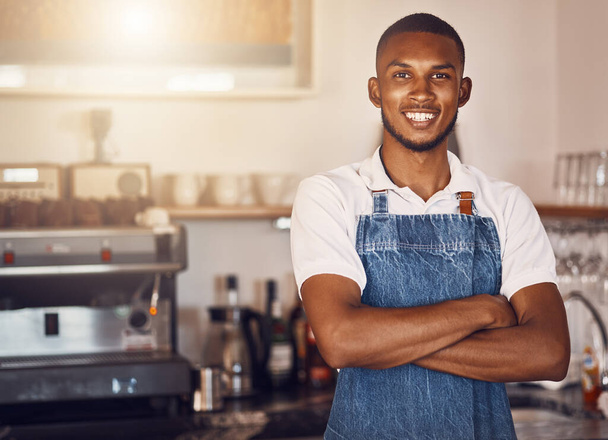 Business owner standing with arms crossed at a cafe, showing pride and success working at a restaurant. Portrait of a waiter, employee or worker giving smile at bakery, looking successful and happy. - Foto, immagini