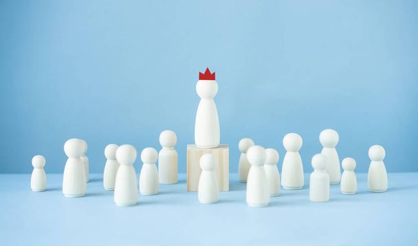 Successful leader concept.Wood doll model on blue background - Foto, imagen
