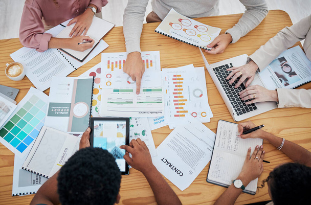 Meeting, planning and finance with a group or team of business people discussing data, a contract or financial report from above. Overhead of a boardroom meeting for strategy, growth and development. - Foto, Imagen