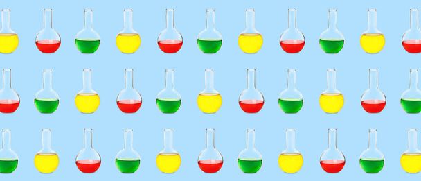 Many laboratory flasks on light blue background. Pattern for design - 写真・画像