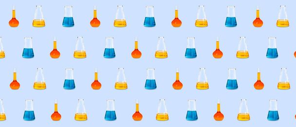 Many laboratory flasks on light blue background. Pattern for design - Foto, afbeelding