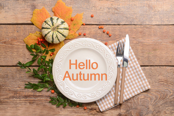 Autumn table setting with pumpkin on wooden background - Фото, изображение