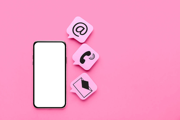 Mobile phone with blank screen and icons on pink background - Photo, Image