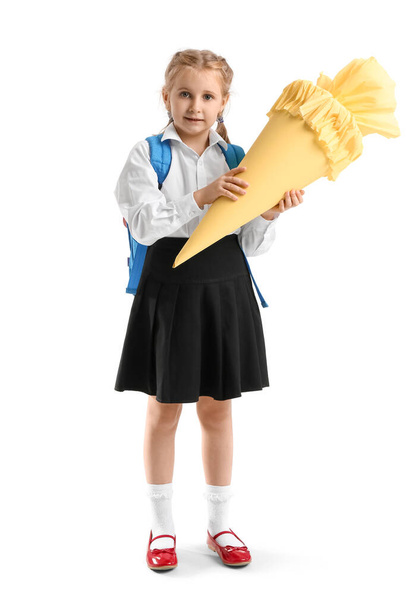Cute little girl with yellow school cone on white background - Foto, Imagen