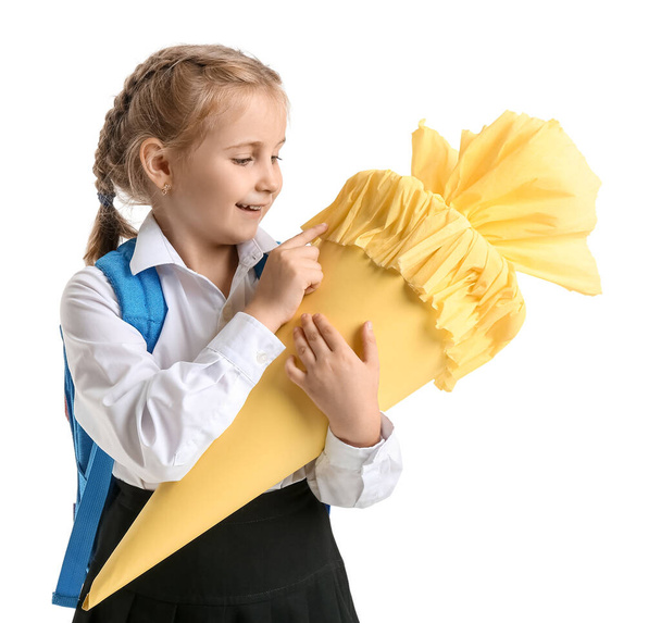 Cute little girl with yellow school cone on white background - Foto, Bild