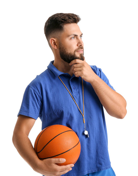 Thoughtful PE teacher with ball on white background - Photo, image