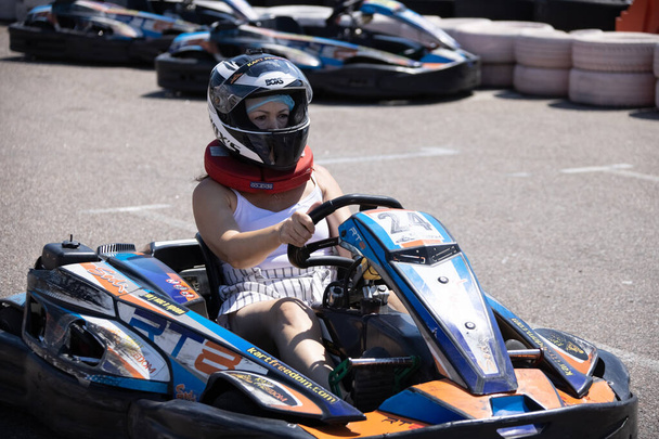 ODESSA, UKRAINE - August 7, 2022: Healthy lifestyle. Sport family. Family vacation at karting track. Children with parents go in for motorsports. Karting. Hobbies, sports education, leisure, lifestyle - Fotó, kép