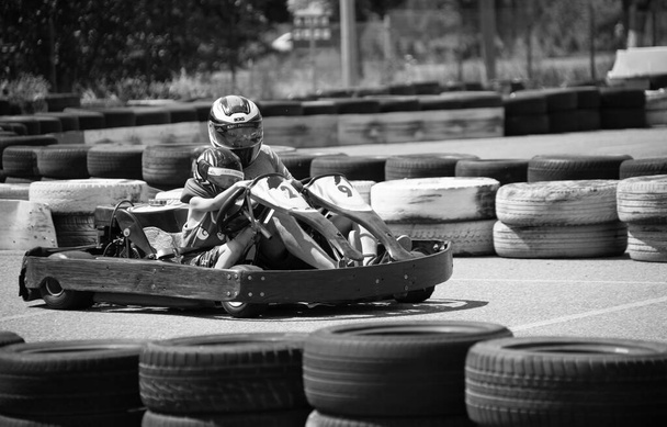 ODESSA, UKRAINE - August 7, 2022: Healthy lifestyle. Sport family. Family vacation at karting track. Children with parents go in for motorsports. Karting. Hobbies, sports education, leisure, lifestyle - Foto, Imagem