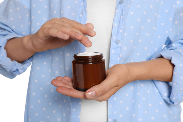 Woman taking hand cream from jar on white background, closeup - Photo, Image