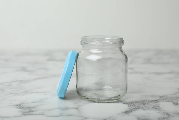Empty glass jar on white marble table - Фото, зображення