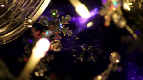 Colorful Christmas lights as multi colored chain of lights for a happy new year and holy eve as festive decoration and ornament for Christmas tree in advent time glowing bright in dark holy night - Footage, Video