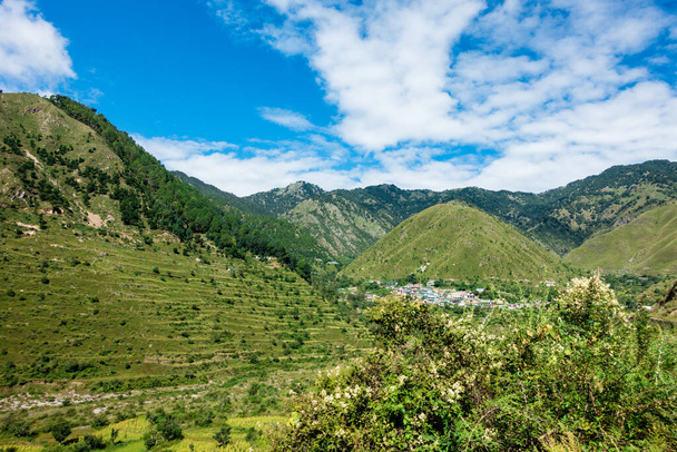 A wide angle shot of a village in the mountains of Lower Himalayan region of Uttarakhand State, India. - Photo, Image