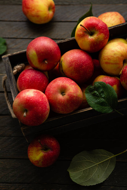 Fresh apples in wooden crate harvest fruits on rustic surface homegrown food - Photo, image