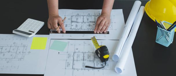 Architects or engineers working construction and drawing construction plans, printing, writing on-site construction sites. Home design concept. - Photo, Image