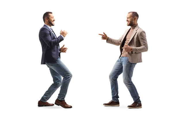 Full length profile shot of two young professional men dancing isolated on white background - Fotó, kép