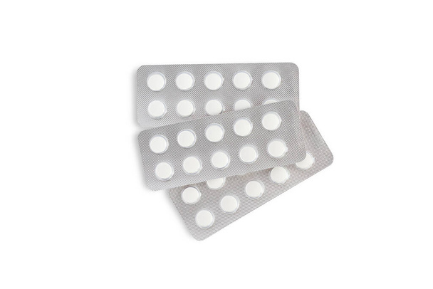 Three blisters of white tablets on a white background - Foto, Imagen