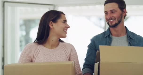 New real estate, house and home sale of a happy and in love couple with cardboard boxes moving in. Young man help a woman with a smile into their building property together after a relocation choice. - Footage, Video
