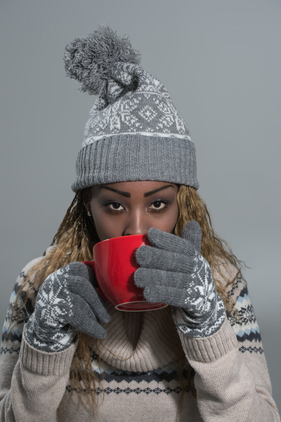 African woman with hot drink - Фото, зображення