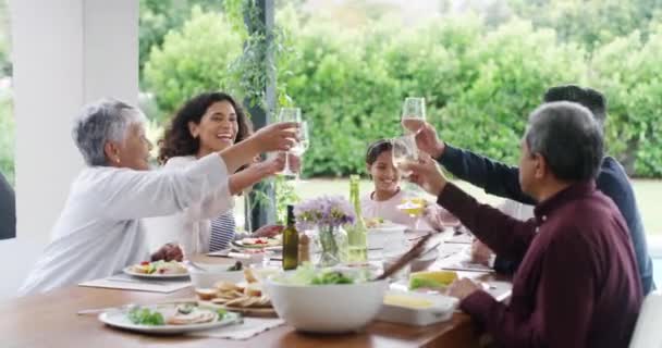 Food, celebration and happy family toasting, having lunch and fun on a patio at a birthday party. Multi generations bonding and laughing at a gathering, celebrating with a meal and cheers outdoors. - Séquence, vidéo