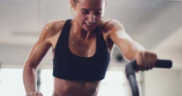 Fitness, gym and woman on exercise bike for routine workout, training or healthy wellness. Sweating, motivation or health coach working on cardio strength goal with intensity energy sports for muscle. - Video