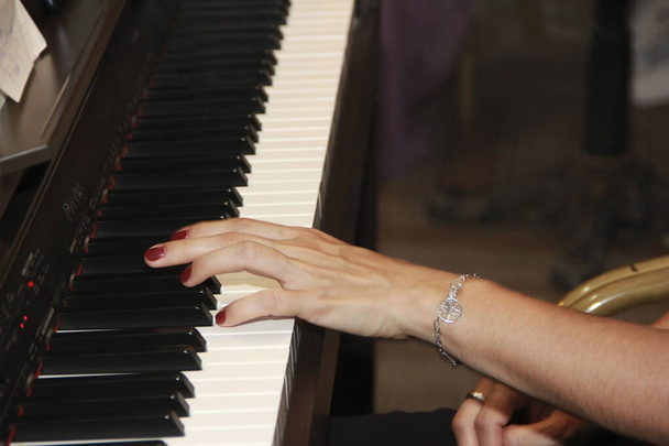 female hands play music on white and black piano keys - Foto, Bild