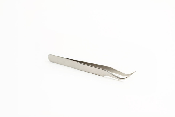 Stainless steel pincers on a white background with coppy space - Fotó, kép