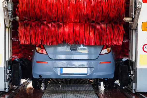 Car wash automatic carwash. Brush washer clean blue auto car on automatic car wash station. Auto carwash machine background - 写真・画像