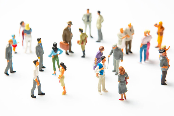 miniature people. different people stand on a white background. communication of society of different generations - Foto, Bild