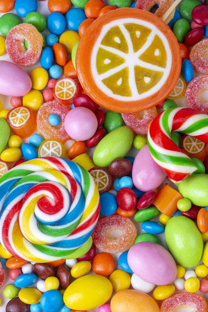 Colorful lollipops and different colorful round candy. Top view. - Photo, Image