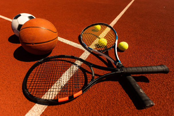 Close-up Of Various Sport Equipments On court Background. - Foto, Imagem