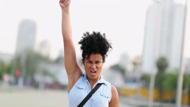Woman activist raising hand and fist in the air in protest - Filmagem, Vídeo