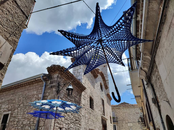 Oratino, Molise, Italy - July 13, 2022: Crochet umbrellas in the alleys of the historic center - Fotografie, Obrázek