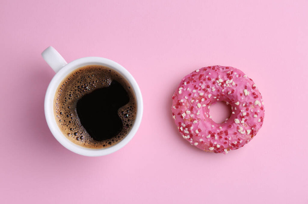 Tasty donut and cup of coffee on pink background, flat lay - Fotoğraf, Görsel