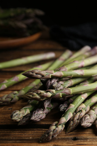 Fresh raw asparagus on wooden table, closeup - Photo, image