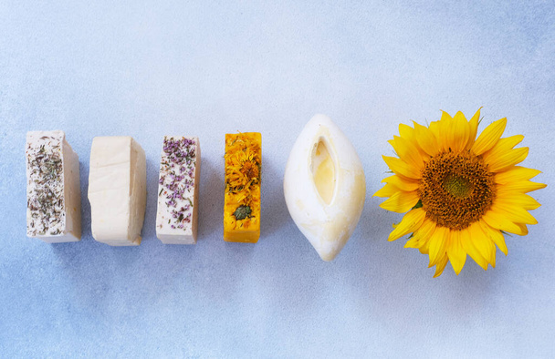 Organic natural set of calendula, lavender, natural and herbal of soap on light colors background. Handmade organic soap concept from natural ingredients. Close-up, top view.  - Fotó, kép
