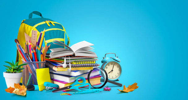 School supplies composition with school bag on turquoise blue background. Copy space - Foto, imagen