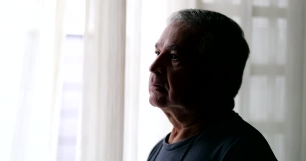 Pensive depressed older man profile in shadow - Materiał filmowy, wideo