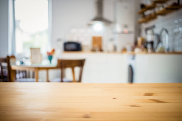 empty wooden tabletop and blurred kitchen mock up for product display - Valokuva, kuva