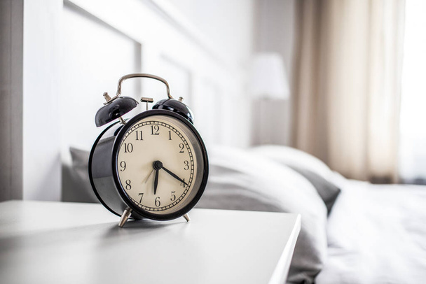 vintage alarm clock in bright bedroom - Photo, image