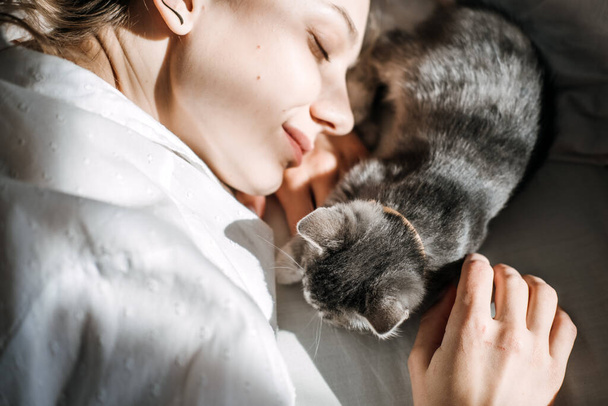 Mindfulness, How to Live in the Moment, Be More Present. Being in the present moment, here and now. Young woman play with kitten at home in morning - Foto, Imagem