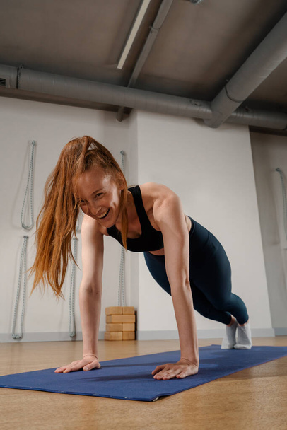 Athletic woman doing pilates yoga stretching for health in the studio. Athletic body girl. - Valokuva, kuva