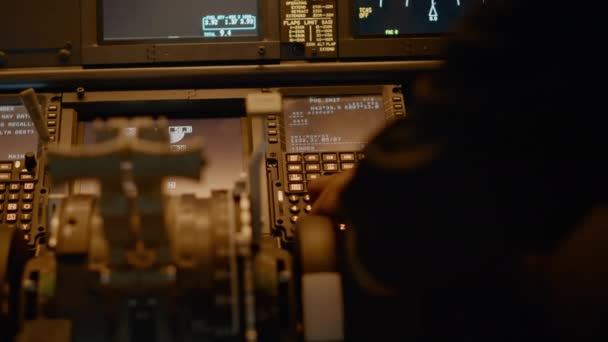 Male copilot inserting flight coordinates to arrive at destination, using dashboard command for navigation. Control panel power buttons and aviation compass, flying aircraft. Close up. - Séquence, vidéo