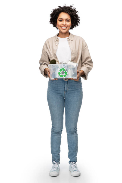 metal recycling, waste sorting and sustainability concept - happy woman holding plastic box with tin cans over white background - Photo, image