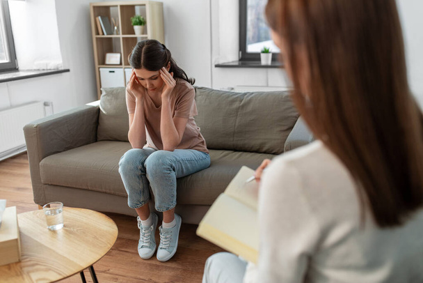 psychology, mental health and people concept - stressed young woman patient and psychologist at psychotherapy session - Φωτογραφία, εικόνα