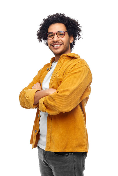 people and fashion concept - happy smiling man in glasses and yellow jacket with crossed arms over white background - Photo, image