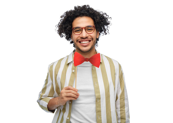 party props, photo booth and people concept - smiling young man with red bowtie over white background - 写真・画像