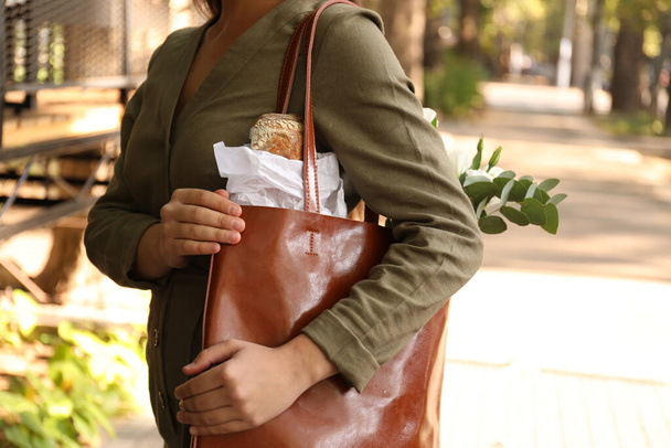 Woman with leather shopper bag on city street, closeup - Foto, immagini