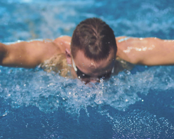 Male swimmer at the swimming pool. Underwater photo. Male swimmer - 写真・画像