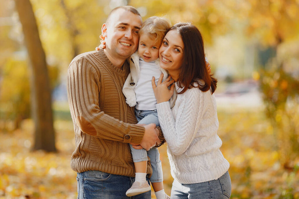 Family with cute little daughter. Father in a brown sweater. Family in a autumn field - Foto, Imagem